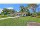 Charming single-story home with a well-manicured lawn and a beautiful shaded front yard at 2462 Hyde Park St, Sarasota, FL 34239