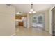 Cozy kitchen with tile floors, sliding glass door to back patio and white appliances at 2462 Hyde Park St, Sarasota, FL 34239