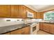 Well-equipped kitchen featuring granite countertops, white appliances, and ample cabinet space at 2462 Hyde Park St, Sarasota, FL 34239