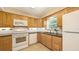 A kitchen featuring wood cabinets, black countertops, and stainless steel appliances at 2462 Hyde Park St, Sarasota, FL 34239