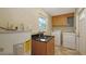 A laundry room with a sink, washer, dryer, and water heater at 2462 Hyde Park St, Sarasota, FL 34239