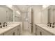 Contemporary bathroom featuring dual sinks, modern faucets, and a glass-enclosed shower at 248 Altamura Cir, Nokomis, FL 34275