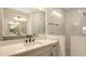 Bright bathroom featuring a white vanity with quartz counters and a walk-in shower with subway tile at 248 Altamura Cir, Nokomis, FL 34275
