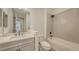 Well-lit bathroom with white vanity, a bathtub with tiled surround, and modern fixtures at 248 Altamura Cir, Nokomis, FL 34275