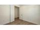 Bright bedroom features wood-look floors and a doorway leading to another room at 248 Altamura Cir, Nokomis, FL 34275