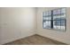 The bedroom features wood-look flooring, two windows with blinds, and clean, neutral walls at 248 Altamura Cir, Nokomis, FL 34275