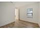 This bedroom features sleek wood flooring, a bright window, and neutral paint at 248 Altamura Cir, Nokomis, FL 34275