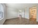 Sunlit bedroom with laminate flooring near a bathroom and entrance at 248 Altamura Cir, Nokomis, FL 34275