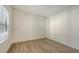 Bright bedroom featuring wood-look flooring and a window with blinds, providing a cozy atmosphere at 248 Altamura Cir, Nokomis, FL 34275