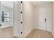 Bright foyer with light wood floors, white trim, and a white front door with sidelights at 248 Altamura Cir, Nokomis, FL 34275