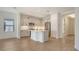 Bright kitchen with stainless steel appliances, white cabinets, and an island with a sink at 248 Altamura Cir, Nokomis, FL 34275
