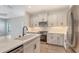 Well-lit kitchen showcasing white cabinets, stainless steel appliances, and tile backsplash at 248 Altamura Cir, Nokomis, FL 34275