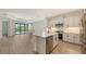 Modern kitchen boasts stainless steel appliances and opens to the light filled living room at 248 Altamura Cir, Nokomis, FL 34275