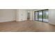 Light-filled living room featuring hardwood floors and glass doors to screened lanai at 248 Altamura Cir, Nokomis, FL 34275
