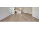 Bright open-concept living room with hardwood floors and modern kitchen at 248 Altamura Cir, Nokomis, FL 34275