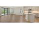 Open-concept living and kitchen area with light wood floors and stainless steel appliances at 248 Altamura Cir, Nokomis, FL 34275
