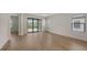 Open-concept living room with wood-look floors and large sliding glass doors overlooking the yard at 248 Altamura Cir, Nokomis, FL 34275