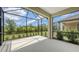 Screened patio with spacious design, offering serene views of the lush outdoors at 248 Altamura Cir, Nokomis, FL 34275