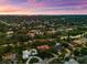 Breathtaking aerial view of a residential area with waterfront properties and a stunning sunset backdrop at 2504 Tanglewood Dr, Sarasota, FL 34239