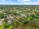 Stunning aerial view of home nestled on a waterfront property with lush greenery and serene water views at 2504 Tanglewood Dr, Sarasota, FL 34239