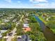Scenic aerial view of a neighborhood with waterfront properties, lush greenery, and a serene canal at 2504 Tanglewood Dr, Sarasota, FL 34239
