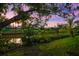 Picturesque backyard with lush greenery, waterfront access, and serene views of the canal at 2504 Tanglewood Dr, Sarasota, FL 34239