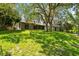The backyard has mature trees and a treehouse at 2504 Tanglewood Dr, Sarasota, FL 34239