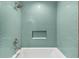 Bathroom tub with hexagon tile surround, brushed nickel fixtures and a built-in toiletry shelf at 2504 Tanglewood Dr, Sarasota, FL 34239