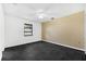 Empty bedroom featuring a textured wallpaper wall, ceiling fan, and dark flooring at 2504 Tanglewood Dr, Sarasota, FL 34239