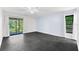 A spacious bedroom with large sliding glass door, ceiling fan and dark tiled floor at 2504 Tanglewood Dr, Sarasota, FL 34239