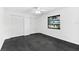 Bright bedroom with dark floors, ceiling fan, and window view of exterior stairs at 2504 Tanglewood Dr, Sarasota, FL 34239