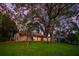 Charming home with a lush green lawn, mature trees, and inviting treehouse at 2504 Tanglewood Dr, Sarasota, FL 34239