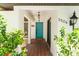 Charming tiled entryway with a vibrant blue door, and views of the courtyard at 2504 Tanglewood Dr, Sarasota, FL 34239