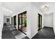 Hallway with interior garden and plenty of natural light from multiple windows at 2504 Tanglewood Dr, Sarasota, FL 34239