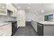 Modern kitchen featuring stainless steel appliances, granite countertops, and sleek white cabinetry at 2504 Tanglewood Dr, Sarasota, FL 34239