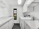 Laundry room with front load washer and dryer, built in shelving, and utility sink at 2504 Tanglewood Dr, Sarasota, FL 34239