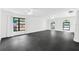Spacious living room featuring black tile floors, lots of natural light, and modern windows at 2504 Tanglewood Dr, Sarasota, FL 34239