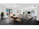 Open-concept living room with black tile floors and ample natural light at 2504 Tanglewood Dr, Sarasota, FL 34239