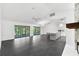 Bright living area features tile floors and open floor plan with view to screened patio and kitchen at 2504 Tanglewood Dr, Sarasota, FL 34239