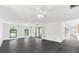 Bright living room featuring black tile floors, modern lighting, and access to the courtyard at 2504 Tanglewood Dr, Sarasota, FL 34239