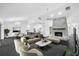 Bright living room features a stone fireplace, modern furniture, and an open floor plan leading to the kitchen at 2504 Tanglewood Dr, Sarasota, FL 34239