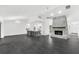 Open-concept living area featuring a stone fireplace, tile floors, and an open layout at 2504 Tanglewood Dr, Sarasota, FL 34239