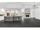 Spacious living area with a stone fireplace, kitchen island with seating, and modern finishes at 2504 Tanglewood Dr, Sarasota, FL 34239
