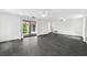 Bright living room featuring black tile floors, modern lighting, and views of the courtyard at 2504 Tanglewood Dr, Sarasota, FL 34239