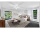 Stylishly furnished main bedroom with a ceiling fan, ample natural light, and a view to the exterior at 2504 Tanglewood Dr, Sarasota, FL 34239
