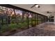 Relaxing screened-in patio offers brick flooring and picturesque views of the landscaped backyard and waterfront at 2504 Tanglewood Dr, Sarasota, FL 34239
