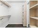 A well-organized walk-in closet with shelving units and wooden racks for optimal storage at 2504 Tanglewood Dr, Sarasota, FL 34239