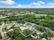 Aerial view of the property showcasing its prime location, mature trees, and proximity to community amenities at 2559 Wood Oak Dr, Sarasota, FL 34232