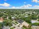 Aerial view of property showing lush surroundings, neighborhood setting, and proximity to a serene lake at 2559 Wood Oak Dr, Sarasota, FL 34232