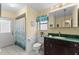 Bathroom features include a vanity with green countertops, tile floors and a shower at 2559 Wood Oak Dr, Sarasota, FL 34232
